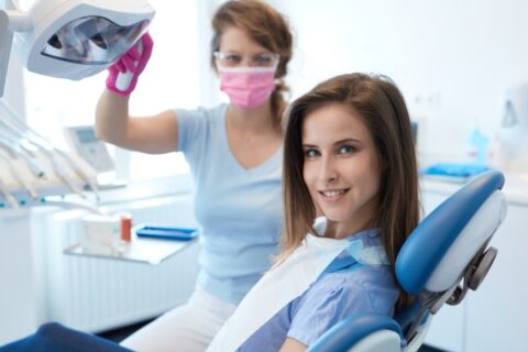 Patient smiling in dental clinic chair.