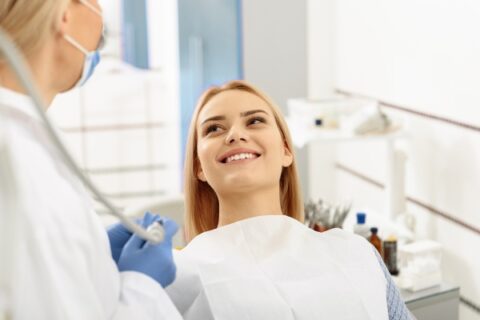 Woman smiling during a dental checkup.